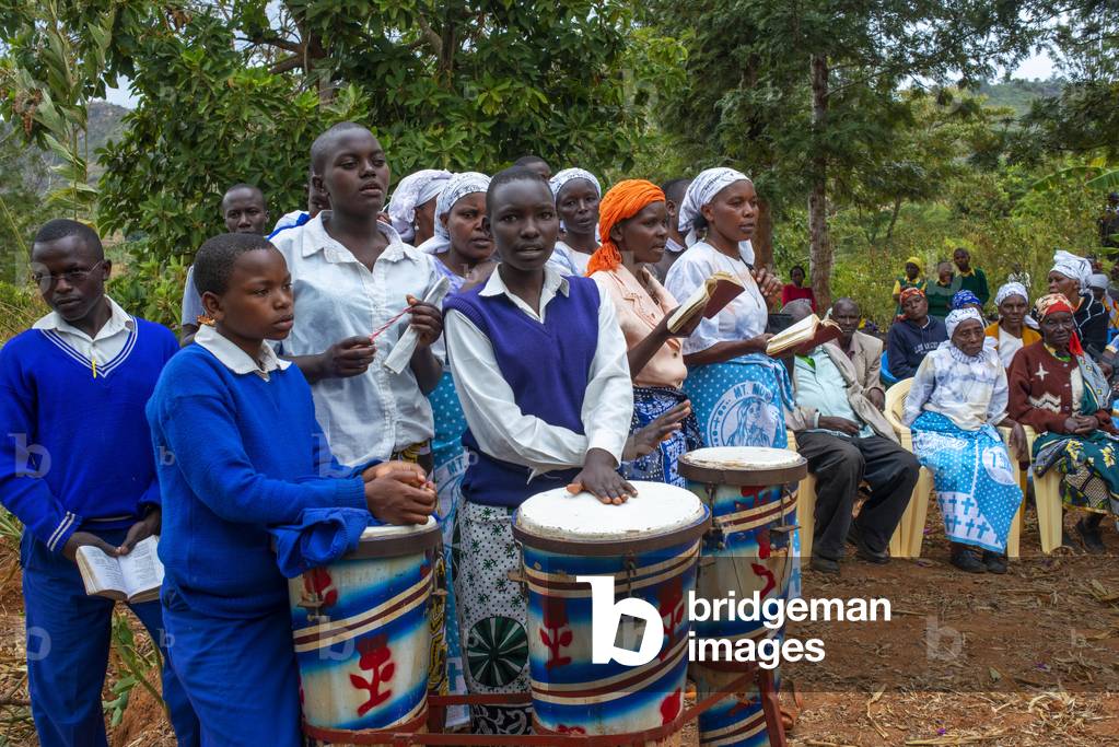 Playing drums in a funeral for the death of a person due to Coronavirus and AIDS in a small village near Kitui city in the Kamba country in Kenya, Africa, 2020 (photo)