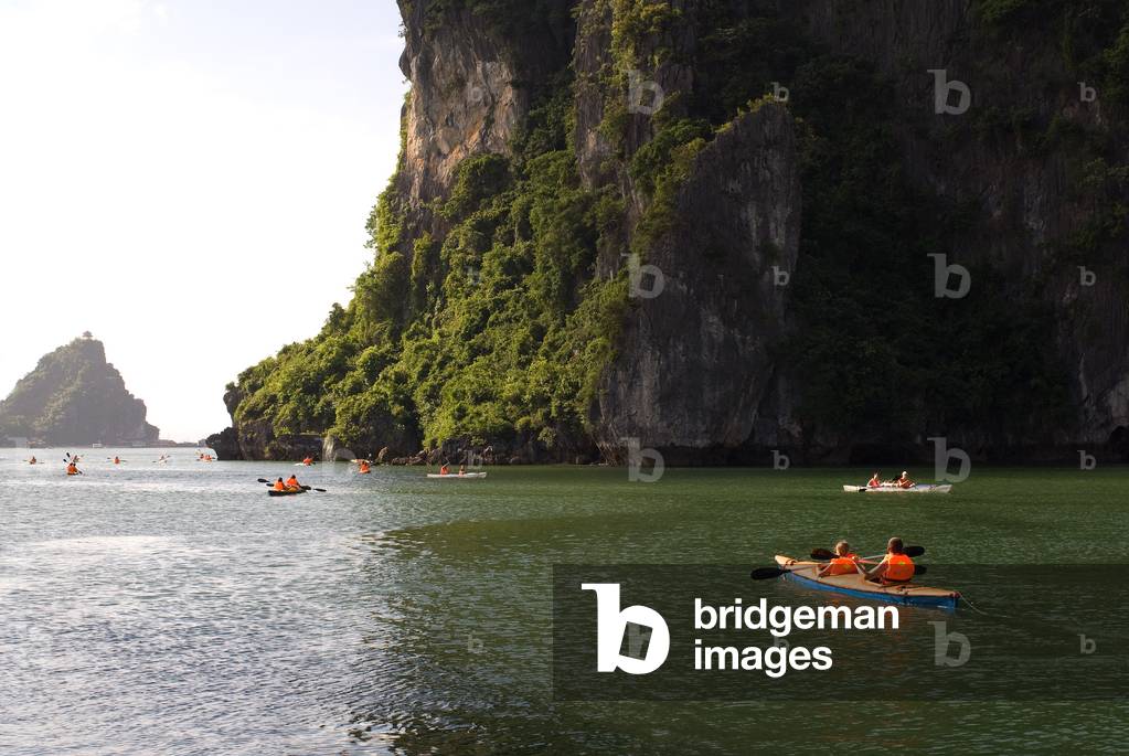 Tourists in Several Kayaks from a Tour Boat in Halong Bay, Vietnam (photo)