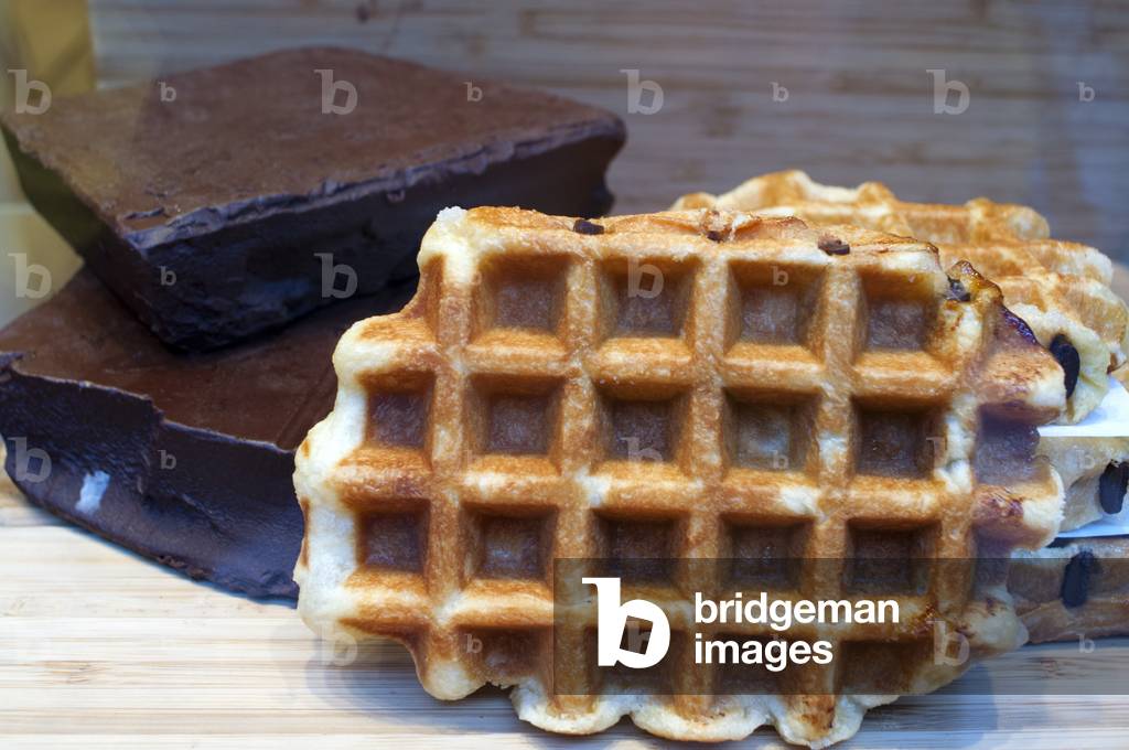 A showcase of a bakery with chocolate wafles advertisement, Brussels, Belgium (photo)