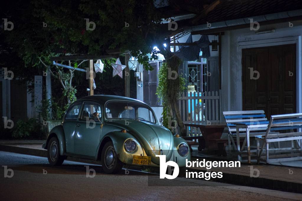 Classic retro car Volkswagen Beetle on the road in Luang Prabang, Laos (photo)