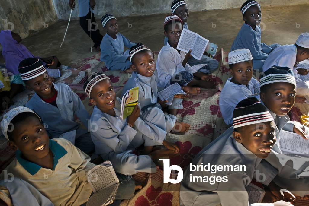 Young Boy in Madrassa (Koranic School), Practicing and reading the Koran, Kizimkazi Dimbani, Zanzibar, Tanzania, Africa (photo)