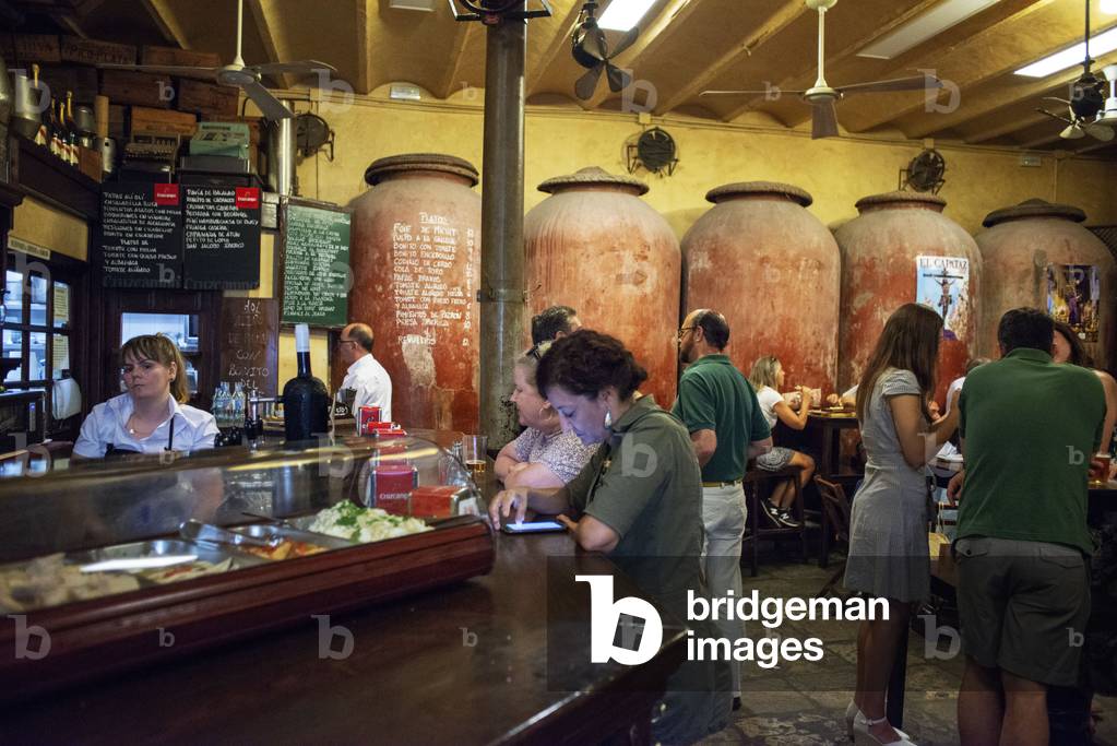 Typical tapas bar food Casa Morales with its wine tanks. Santa Cruz district, Sevilla, Andalucia, Spain (photo)