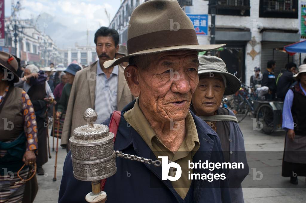 Tibetan buddhist devotees doing the Kora clockwise circumambulation around Jokhang temple, Lhasa Tibet (photo)