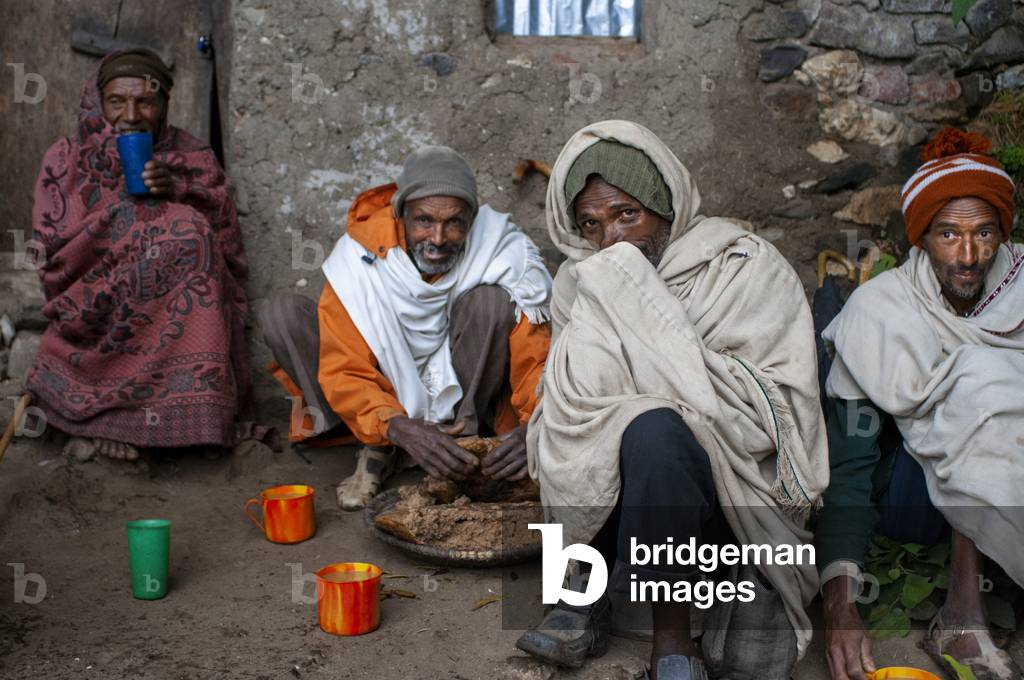 Local people sharing food in nakuto lab cave church, Amhara region, Lalibela, Ethiopia (photo)