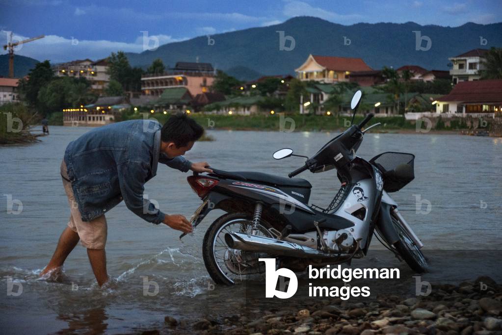 Clean the motorbike in Nam Song river next to Vang Vieng village, Laos (photo)