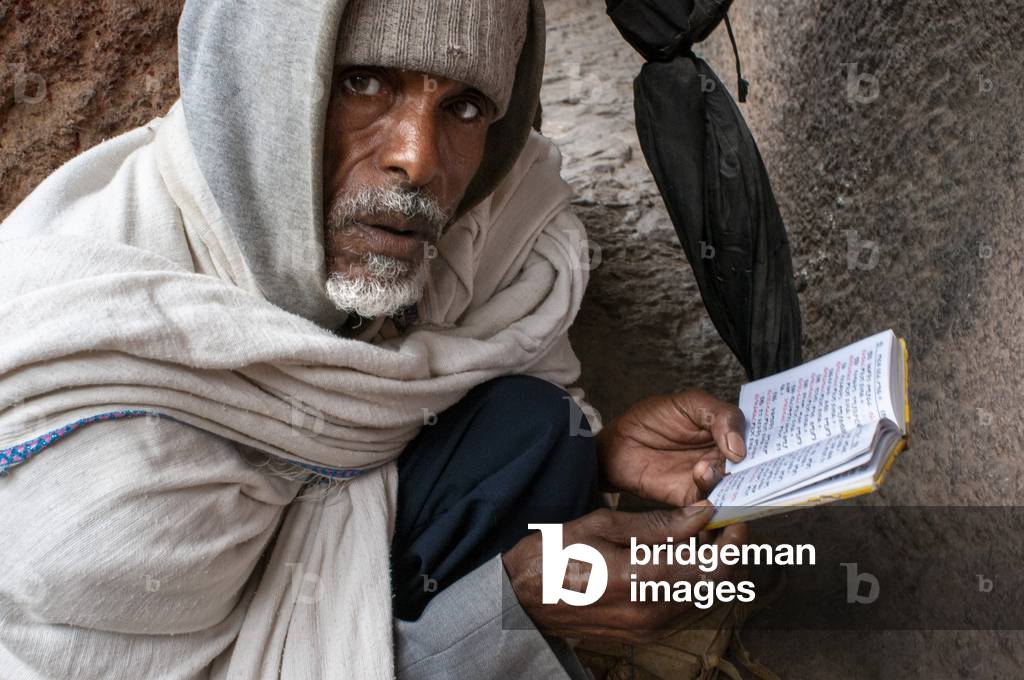 Priest reading the bible, Lalibela, Ethiopia, Africa, Bete Giyorgis and Bet Golgotha and Bet Mikael churches, Lalibela Rock Hewn Churches, UNESCO World Heritage Site, Northern Ethiopia, Africa (photo)