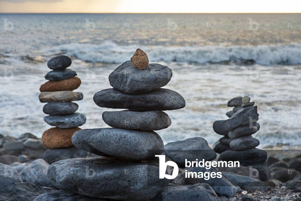 Art of stone balance or rock stones piles at Beach Playa de Caleta Tenerife Island, Canary Islands, Spain (photo)