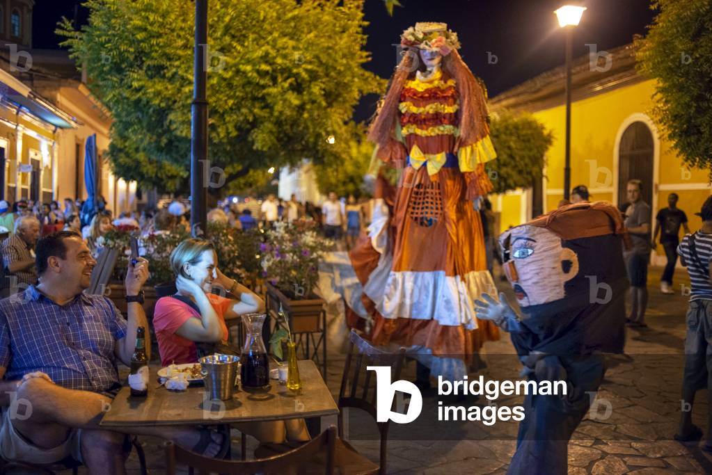 Gigantona dress in La Calzada a gastronomic street in Granada Nicaragua with lots of tourists and locals enjoying fine food outdoors. Granada, Nicaragua, Central America, America (photo)