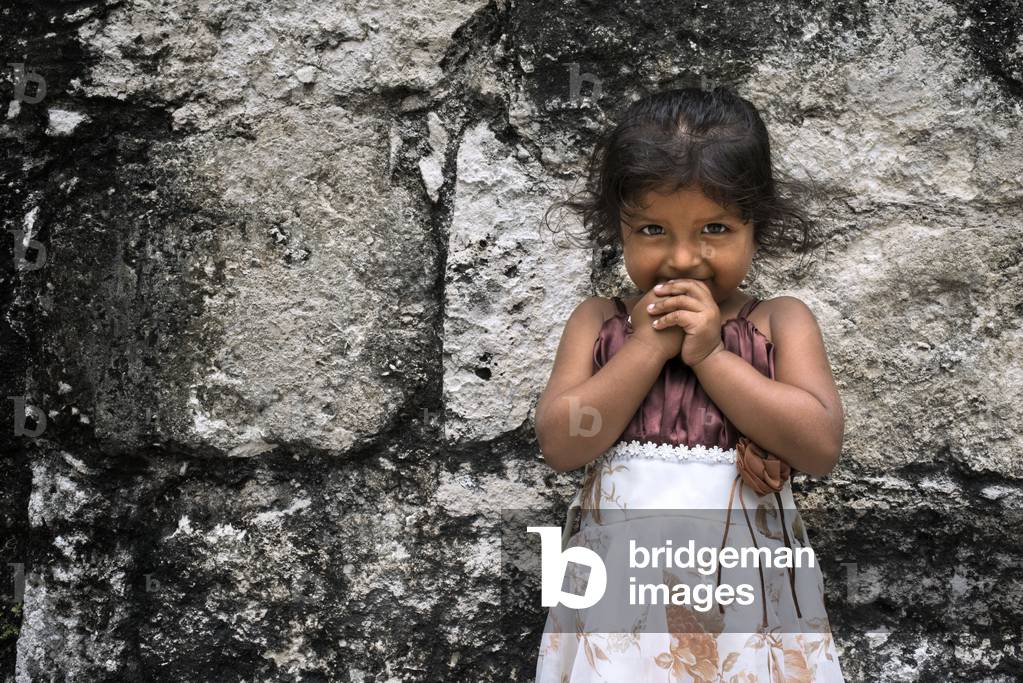 Local Girl in Tikal Pyramid ruins (UNESCO site), Guatemala, Great Jaguar Temple (Temple I) Pre-Columbian Maya Site at Tikal, El Peten National Park, Guatemala, a UNESCO World Heritage Site, 2020 (photo)