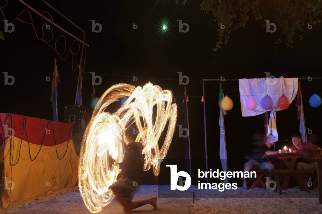 Man performing fire poi, Railay beach, Krabi, Thailand (photo)