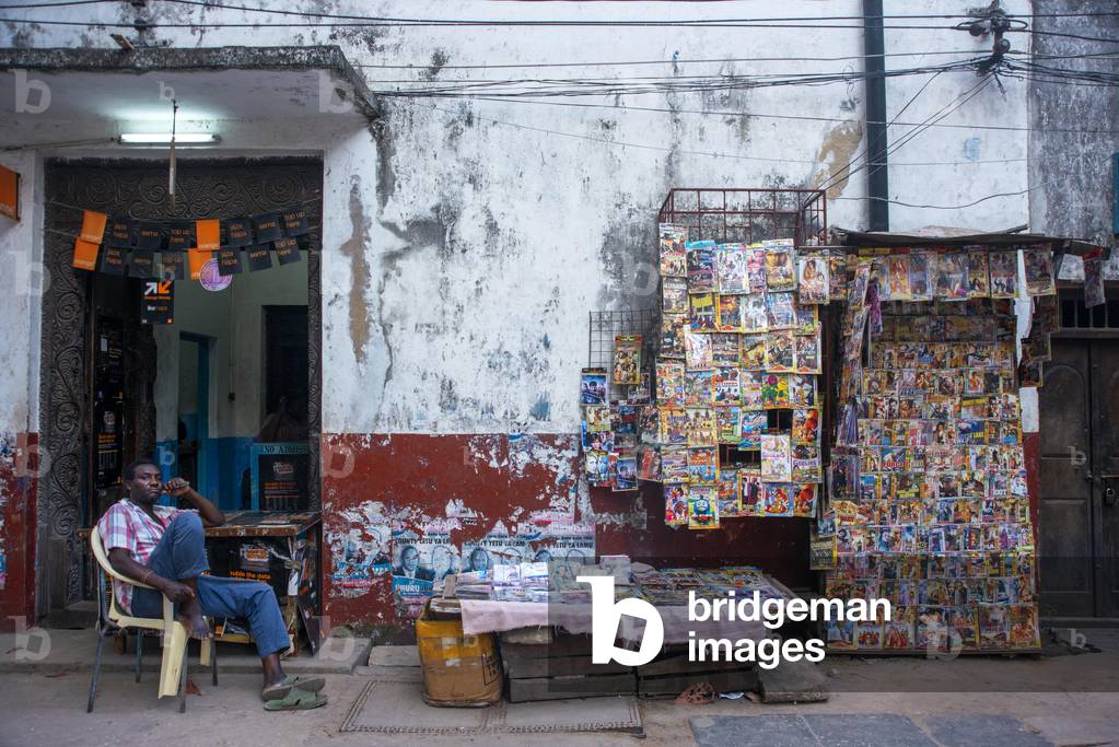 Magazine shop stall in a narrow street of Lamu town in Lamu Island, Kenya, 2020 (photo)
