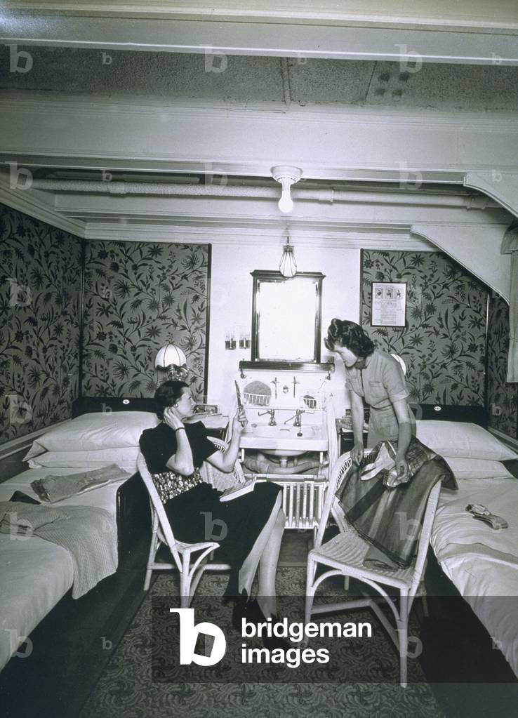 Maid helping her mistress undress aboard the RMS Scythia (b/w photo)