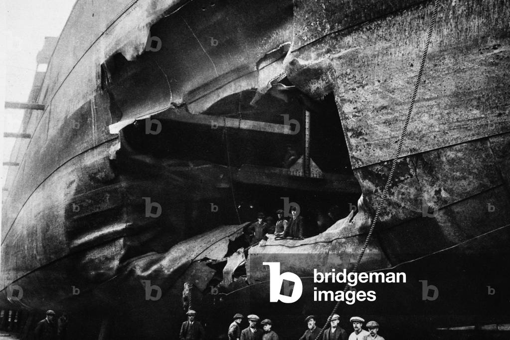 A torpedo-damaged cargo ship in dock, from 'The Illustrated War News' (b/w photo)