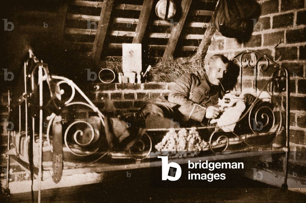 Resting between duties, a British Officer in his crude but comfortable billet in France, from 'The Illustrated War News' (b/w photo)