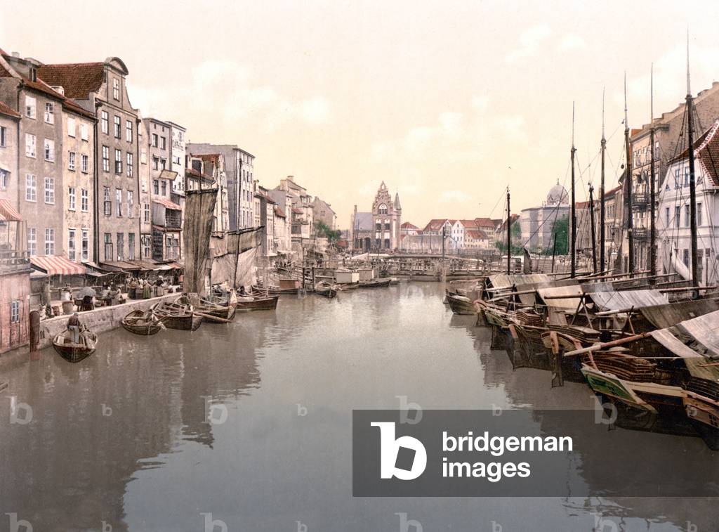 View down canal in Konigsberg with market on left and fishing boats moored on right, Konigsberg, Germany, pub. c.1895 (postcard chromolithograph)