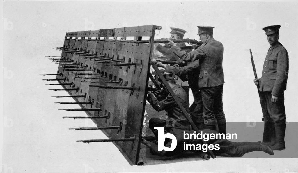 Forming a barricade of armour: bullet-proof shields set in a row as a road-defence, or for like purpose, from 'The Illustrated War News' (litho)