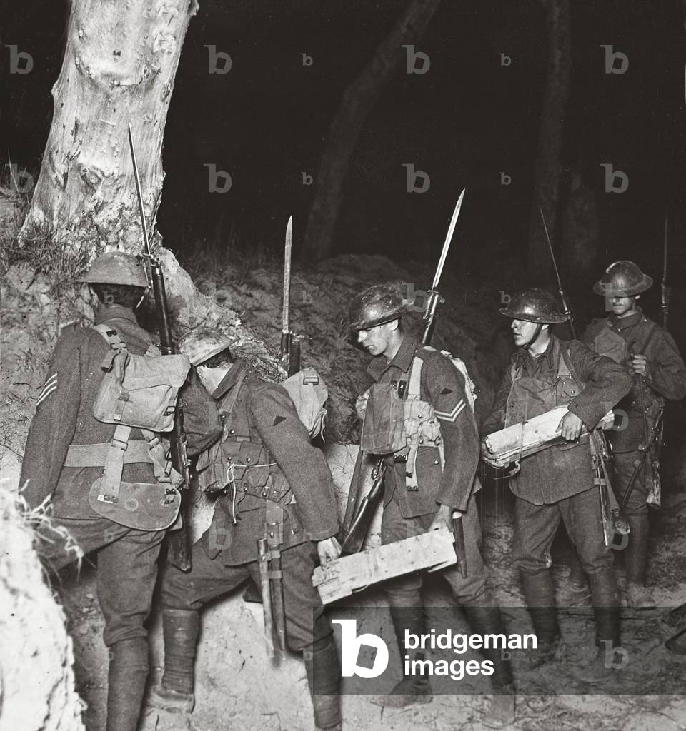 Our troops leaving by a sap on a night operation to cut off the 'Huns' holding on to Villers-Bretonneux, 1918 (b/w photo)