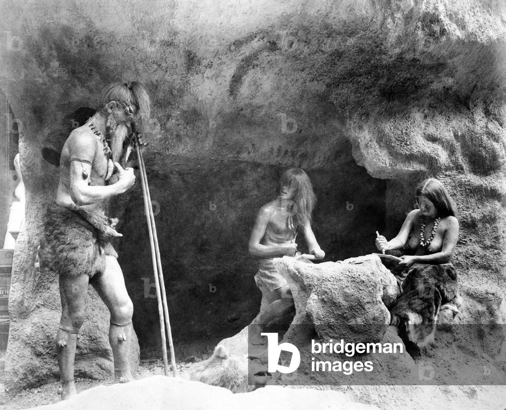 Stone Age people making flint instruments, Paris Exhibition, 1889 (b/w photo)