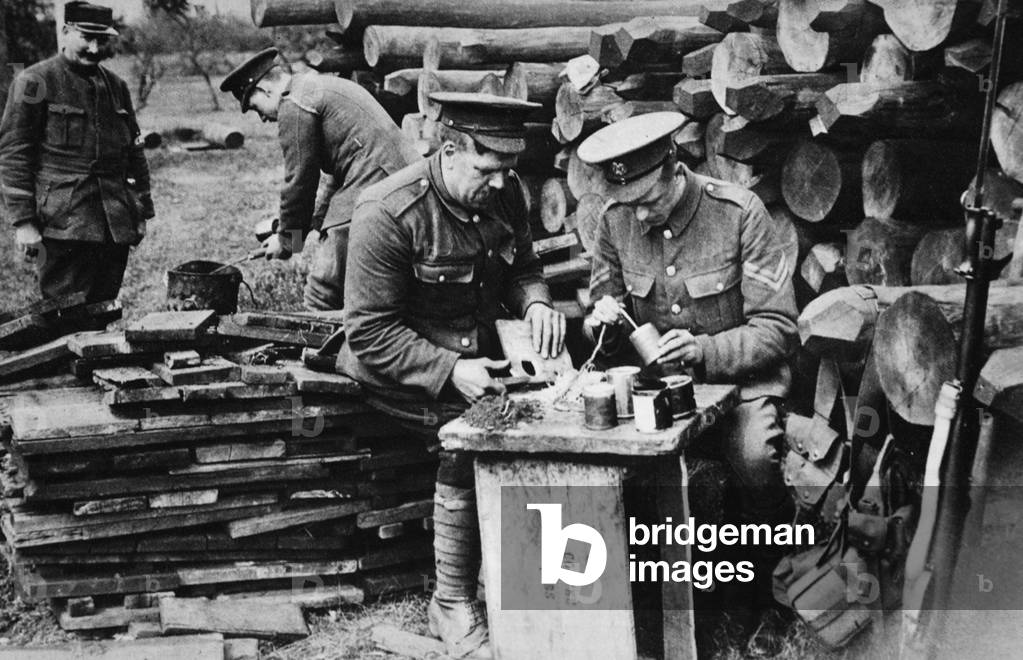 Tobacco-tins as hand-grenades: men of the Royal Engineers loading reserve stocks in rear of the trenches, from 'The Illustrated War News' (b/w photo)