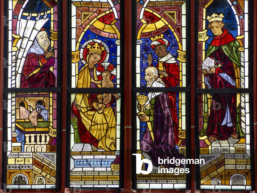 Stained glass window scene of the Adoration of the Magi (1406) at 15th century fortified church, Ingelheim (colour photo)