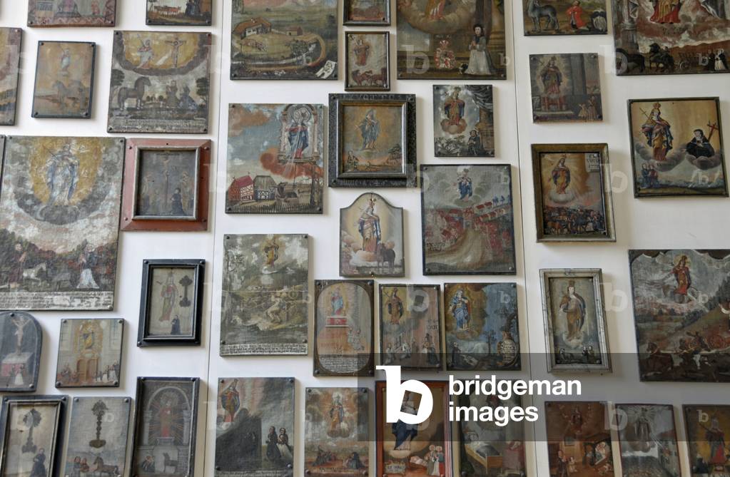 Votive tablets on the wall in the pilgrimage church of Maria Steinbach, Germany (photo)