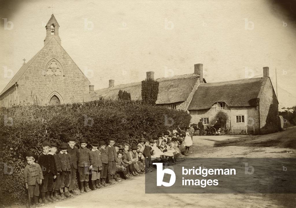 Group portrait of village children, UK, c.1900 (b/w photo)
