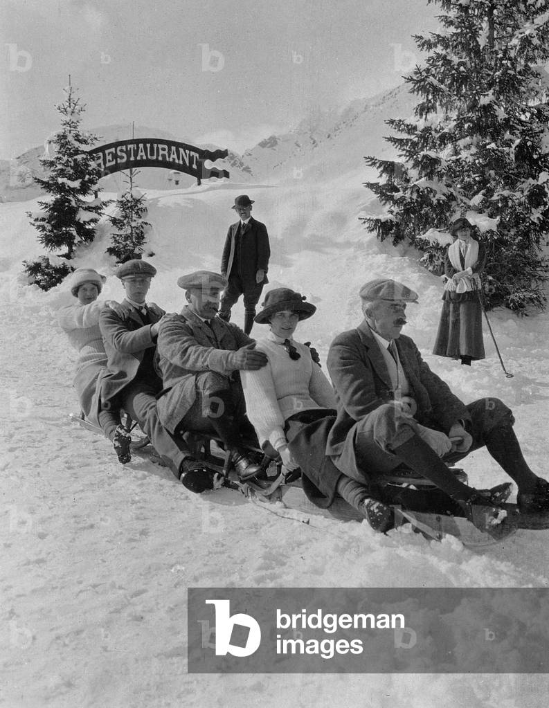 Patricia, Peter, Mr. Milne, P. L-B and Dr. Somers on a toboggan, c.1910 (b/w photo)