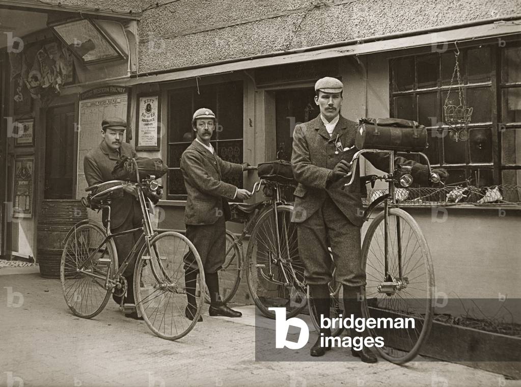 Portrait of three young men with bicycles outside a train station, Kent, UK, c.1920 (b/w photo)