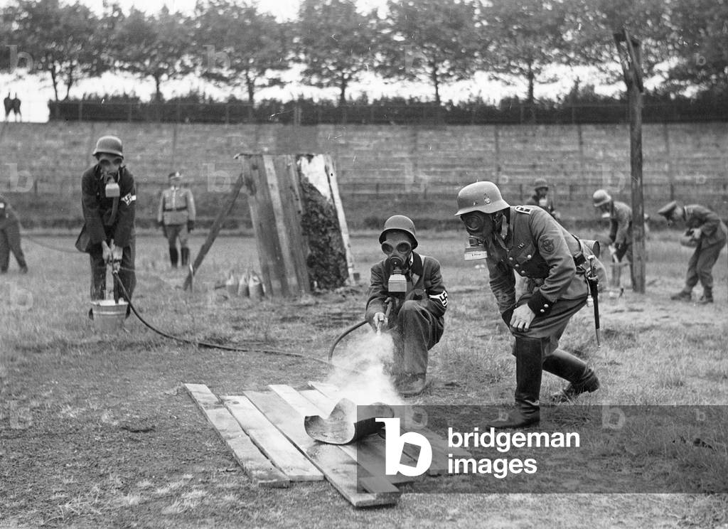 Demonstration on how to extinguish a firebomb, 1943 (b/w photo)
