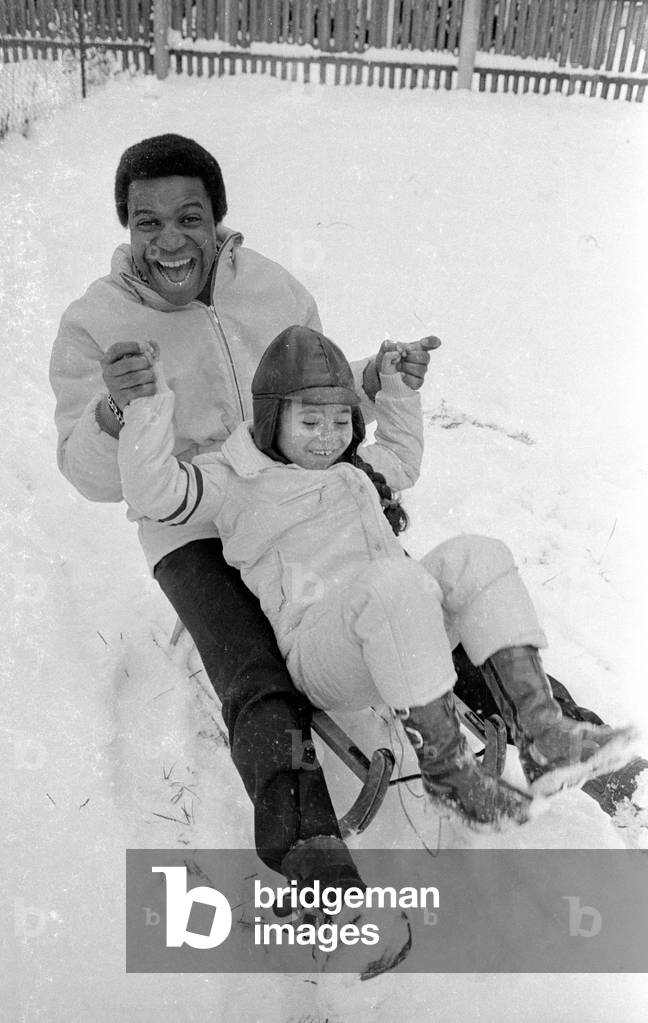 Roberto Blanco with sledge, 1970 (b/w photo)