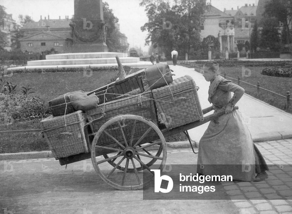 Female luggage carrier, 1911 (b/w photo)