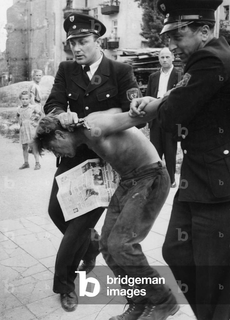 Sergeant Hans Gropp making an arrest, 1952 (b/w photo)