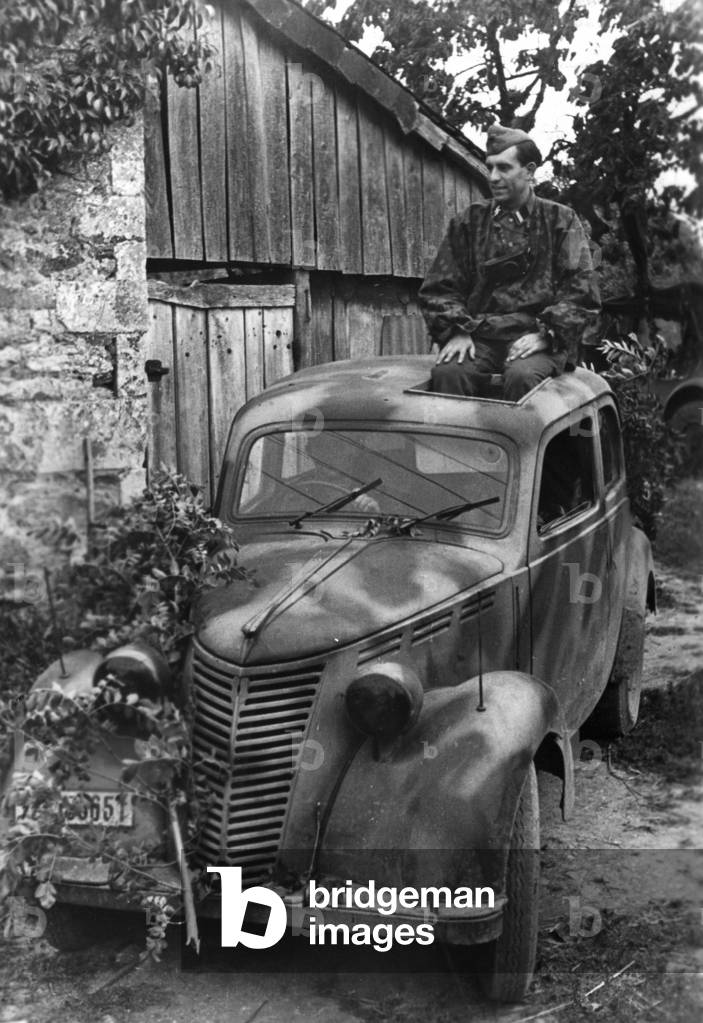 Camouflaged German car in Normandy, 1944 (b/w photo)