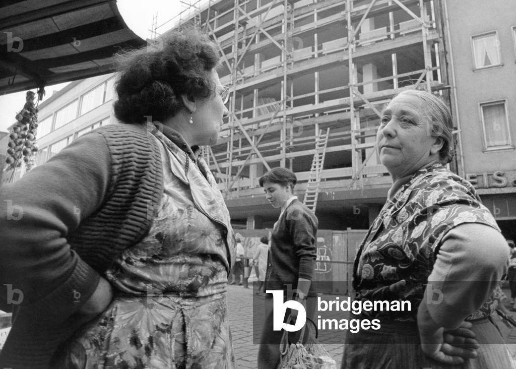 Two elderly women on a street (b/w photo)