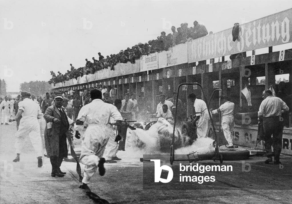 Grand Prix of Germany at the Nuerburgring: fire-fighting operations at the car of von Brauchitsch, 1938 (b/w photo)