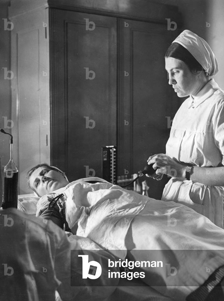 Red Cross nurse donating blood, 1940  (b/w photo)