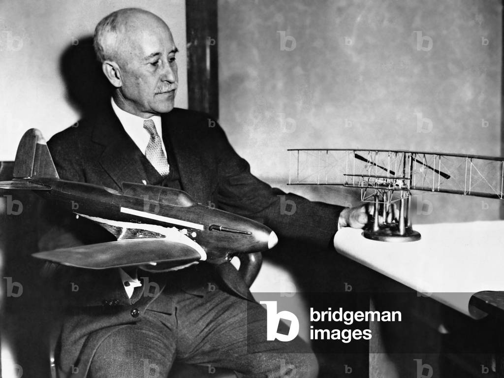 Orville Wright with airplane models, 1935 (b/w photo)