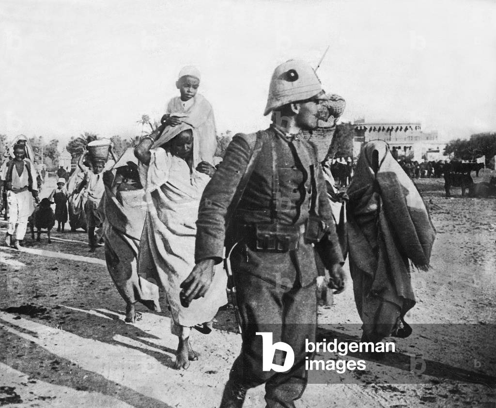 Italian soldiers lead away arrested civilians, 1911 (b/w photo)