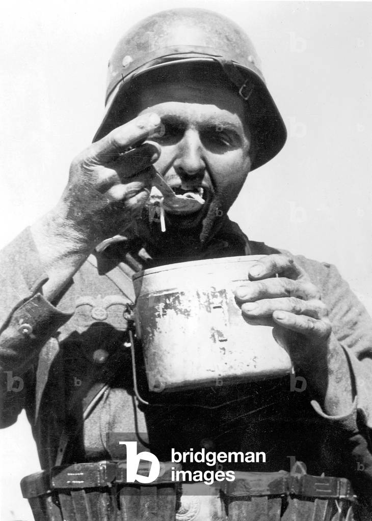 German soldier eats (b/w photo)
