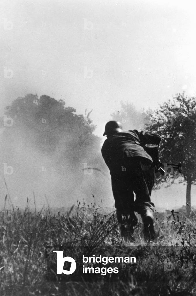 Wehrmacht soldier during the retreat fights in France, 1944 (b/w photo)