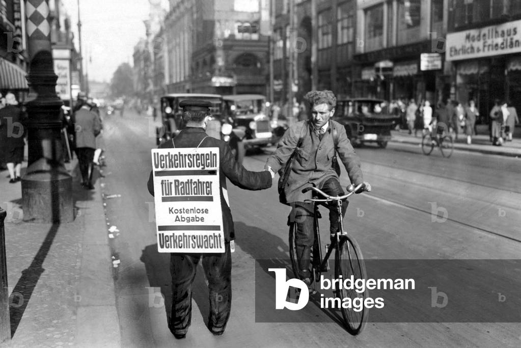 Distribution of new traffic laws to cyclists, 1929 (b/w photo)