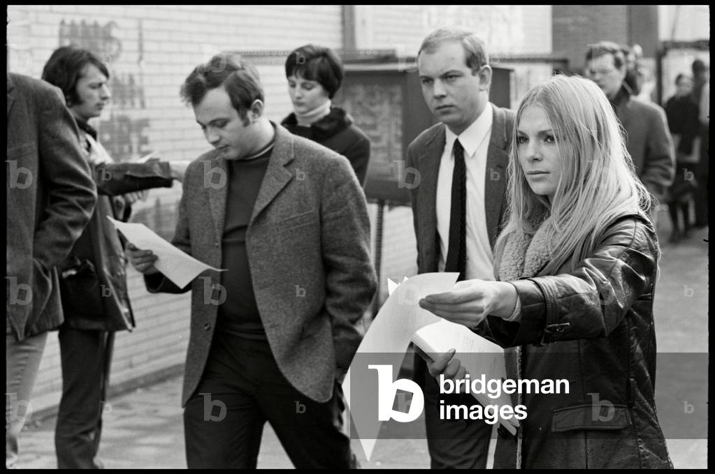 Annette Bauer handing out SDS flyers (b/w photo)