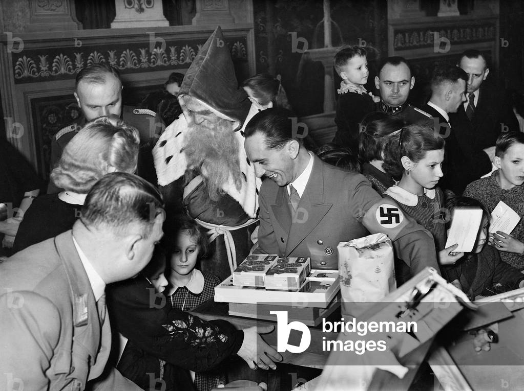 Joseph Goebbels presents children with a Santa Claus, 1935 (b/w photo)