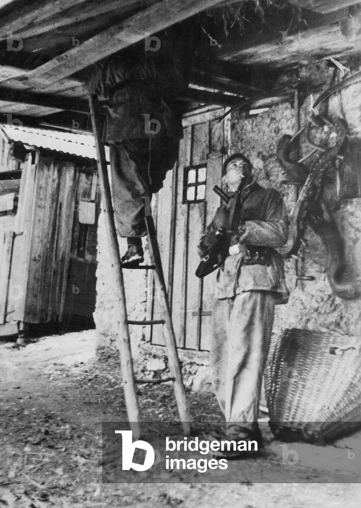 Waffen-SS sifts through a house in search of partisans, 1945 (b/w photo)