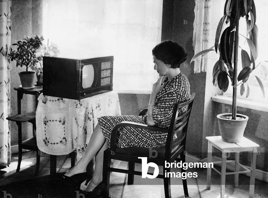 Woman watching television, 1938 (b/w photo)