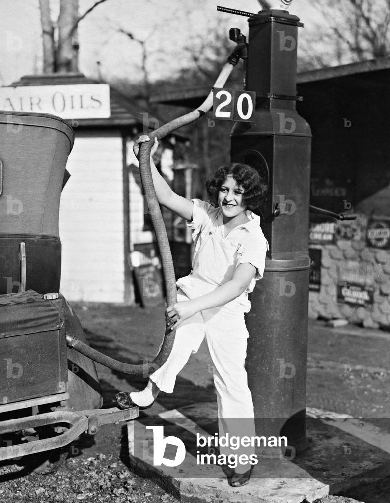 A girl while refueling, 1932 (b/w photo)