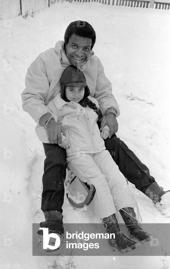 Roberto Blanco with sledge, 1970 (b/w photo)