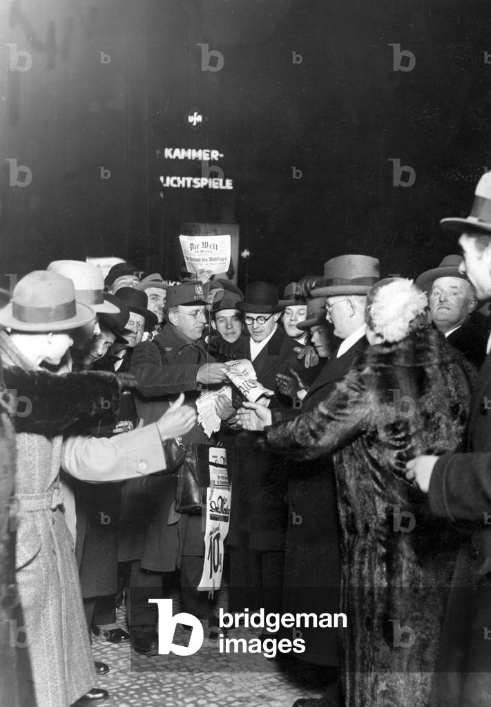 Newspaper salesman sells newspapers with the election results, 1932