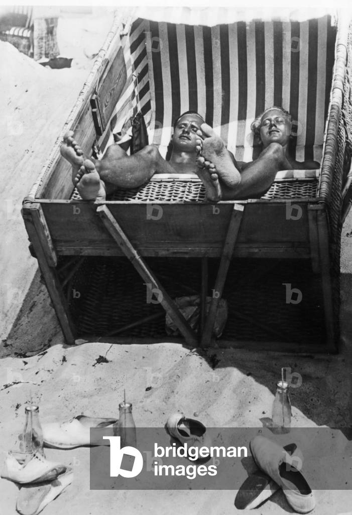 Sunbathing in a beach chair, 1933 (b/w photo)