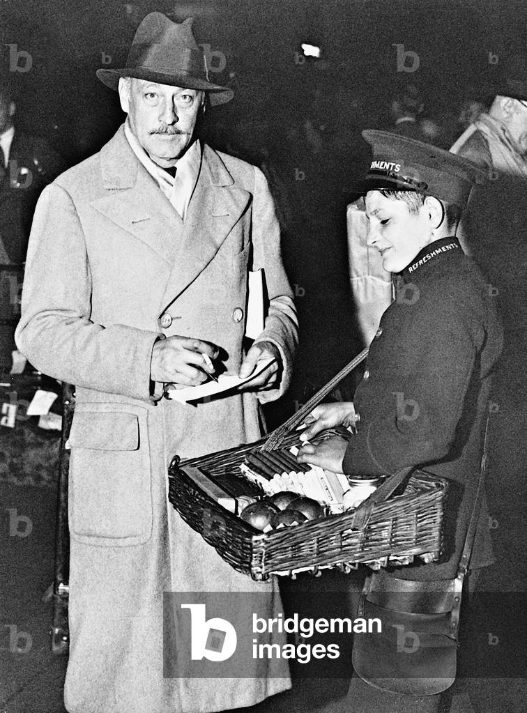 John Barrymore gives autographs, 1934 (b/w photo)